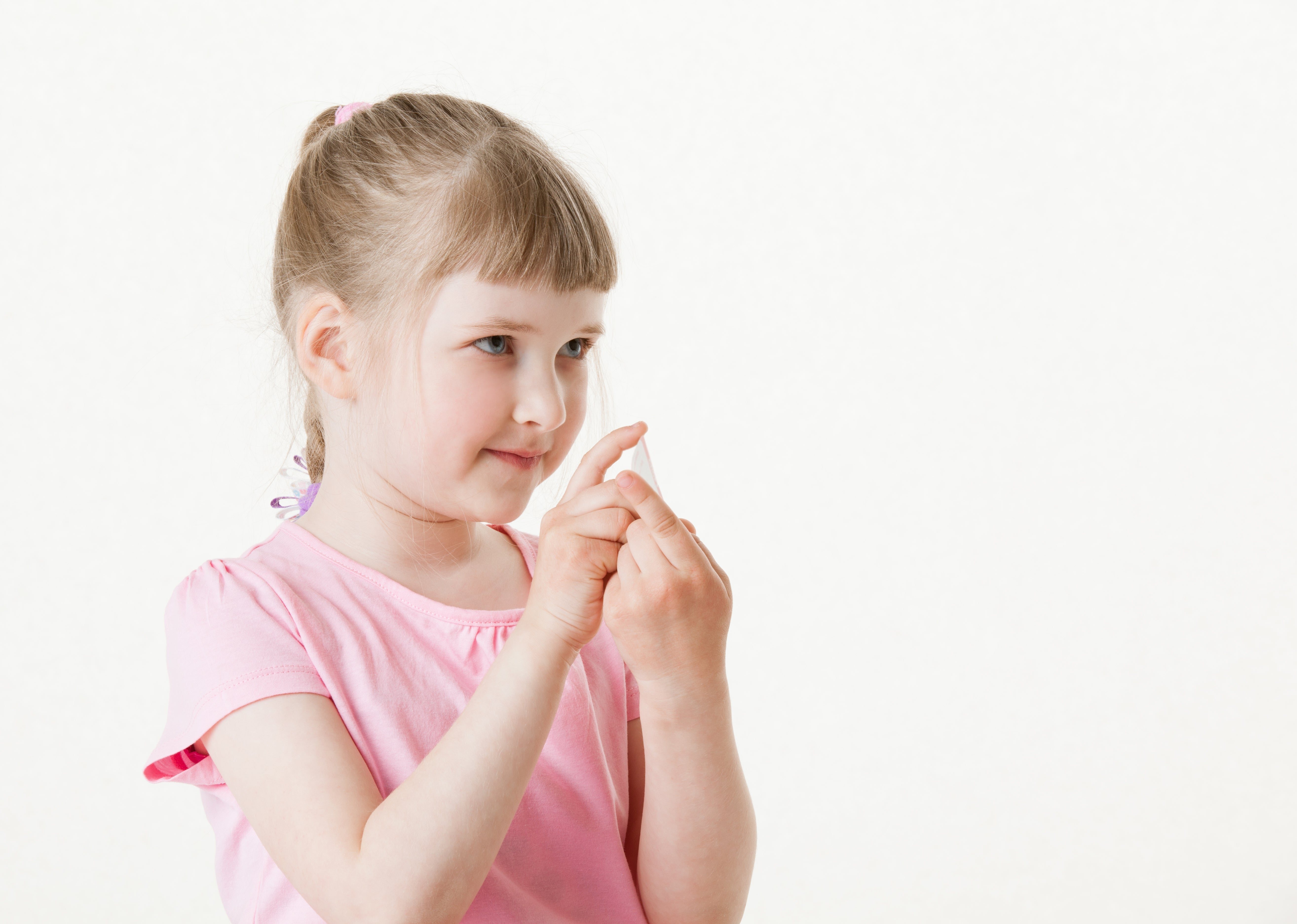 young girl holding up one of Hummingly's Chatter Patter cards