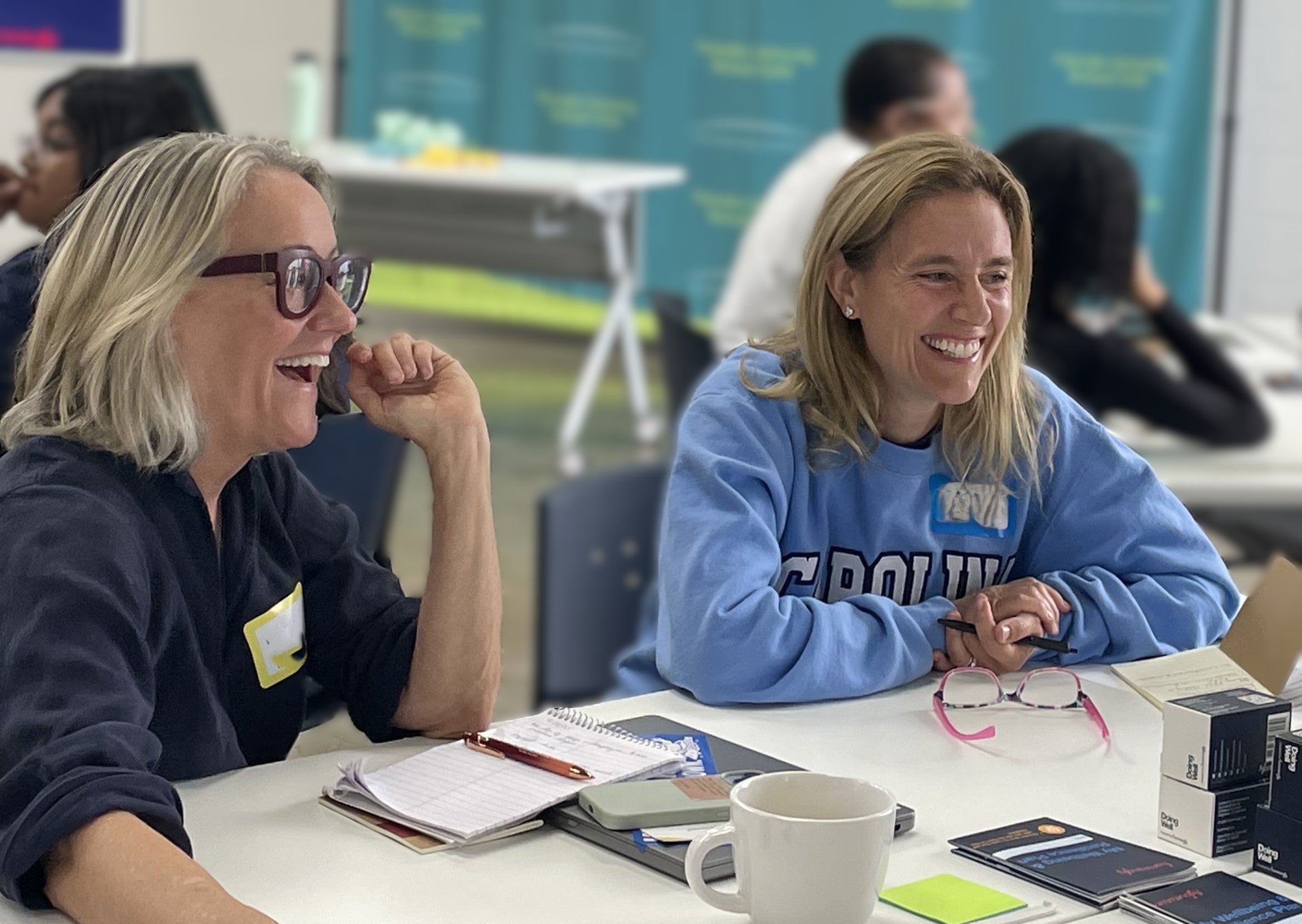 2 women laughing at a Hummingly sustaining the supporters workshop after disaster